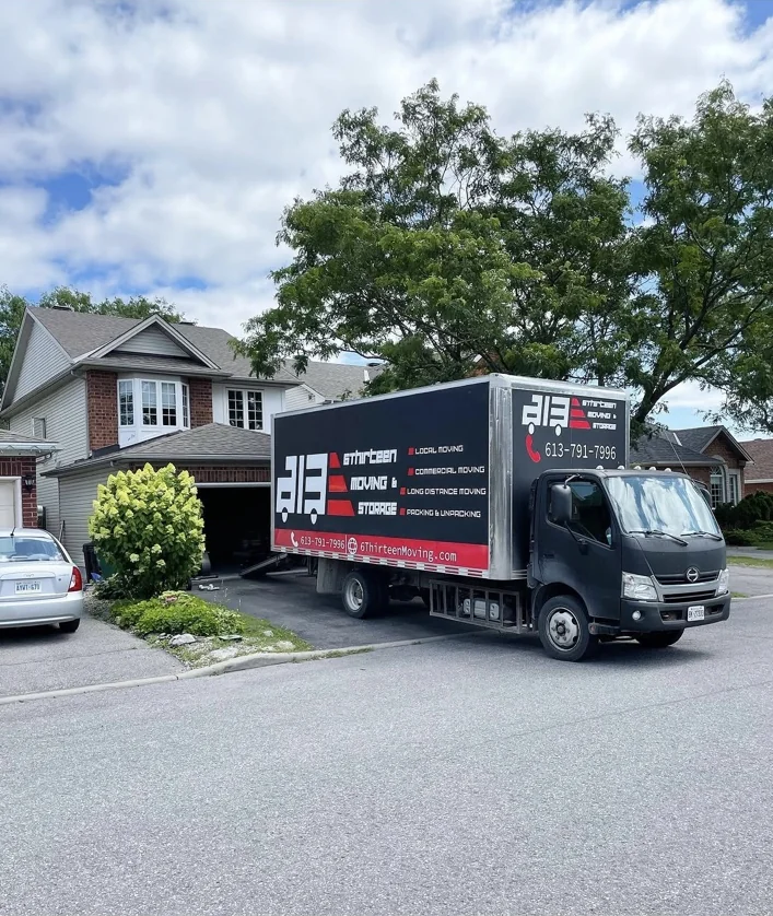 6Thirteen Moving & Storage truck outside a house on a sunny moving day